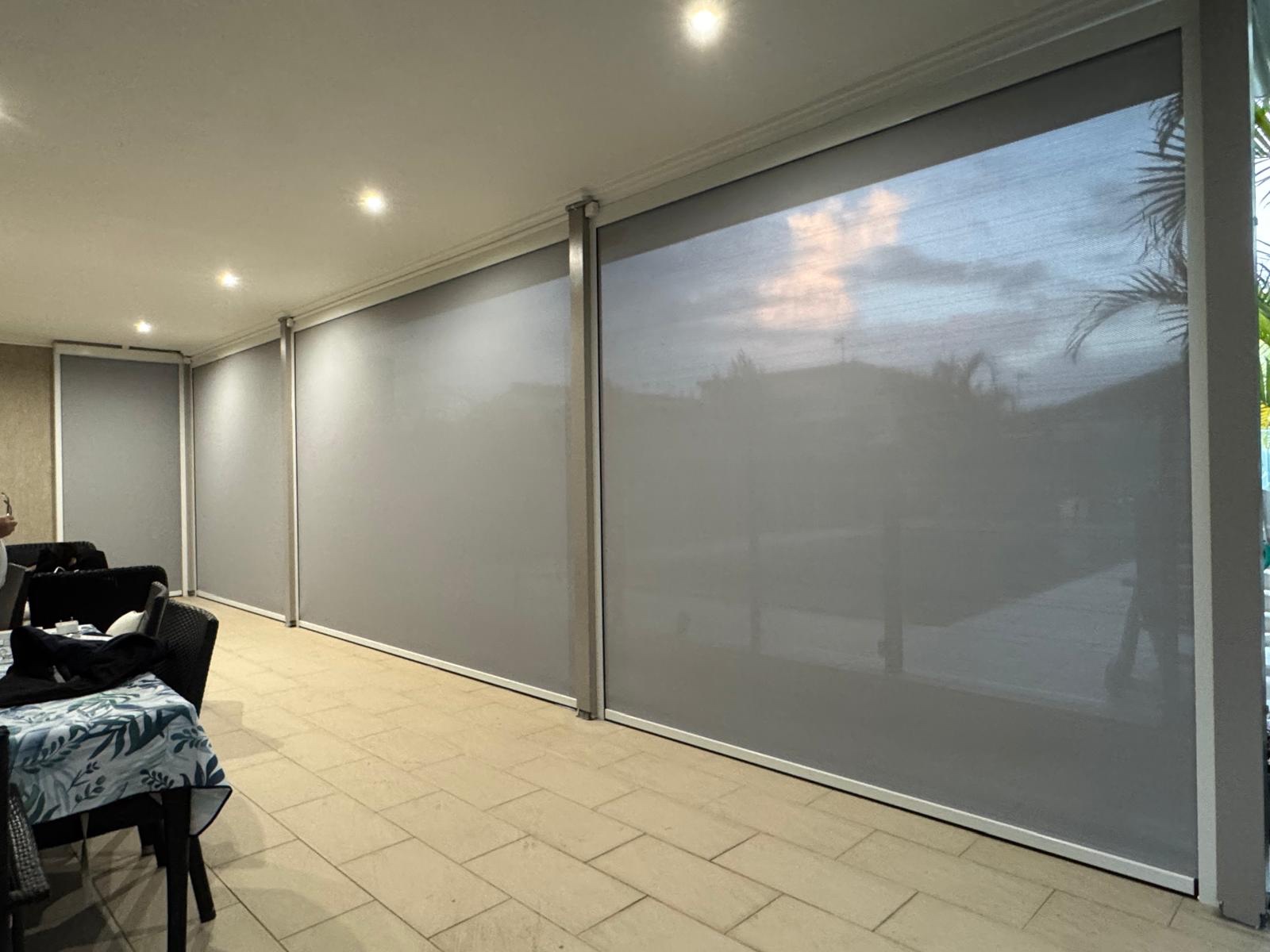 Outdoor blind installation on a modern home